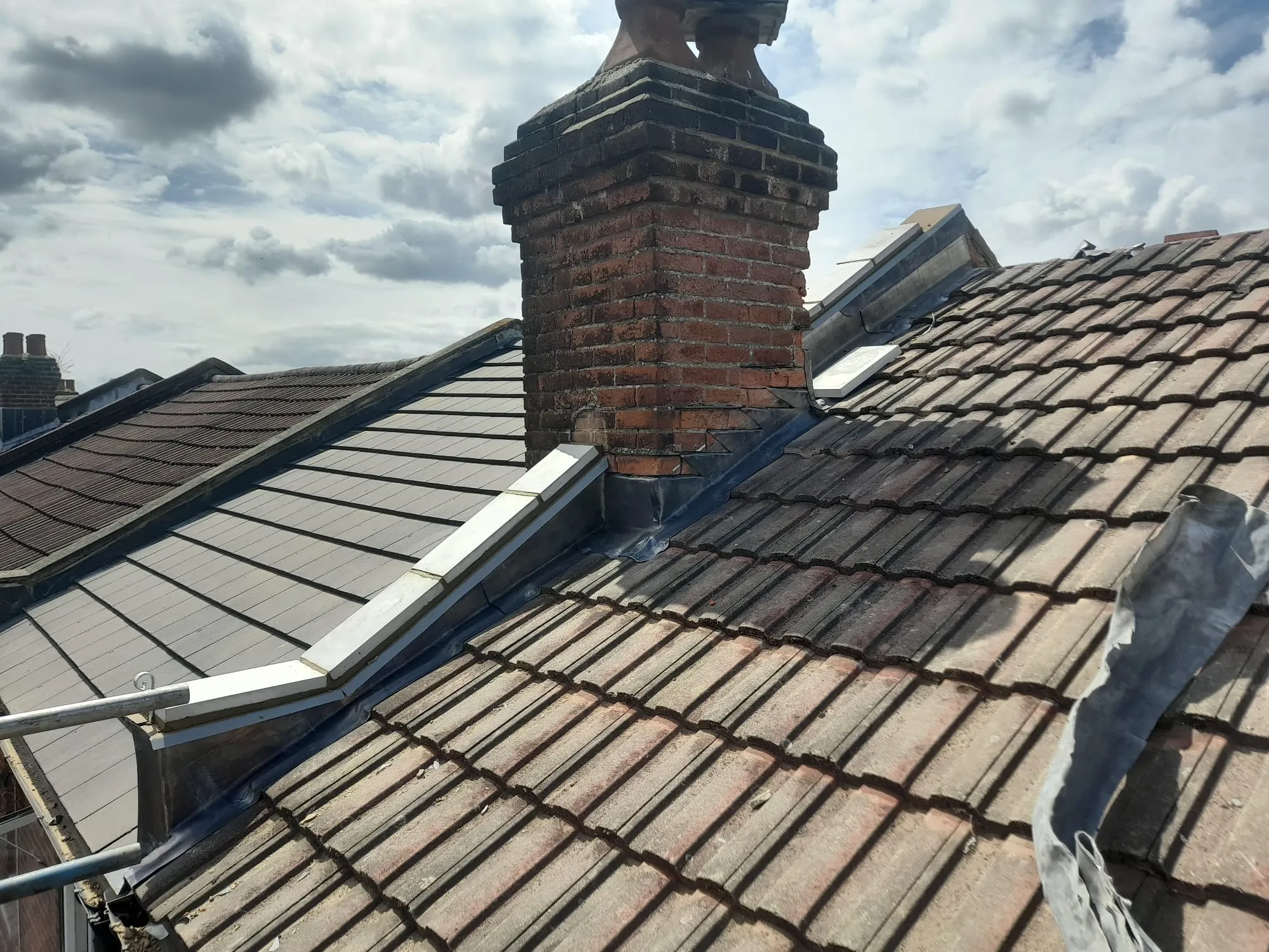 A brick chimney on top of a roof.